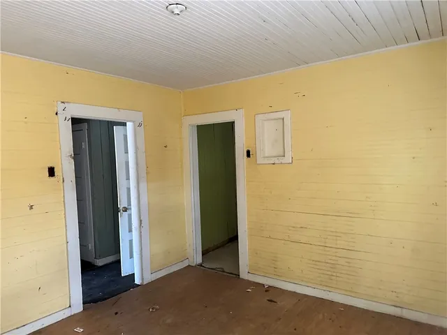 a view of an empty room with a fireplace