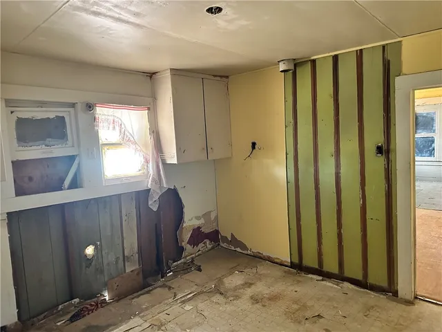 a view of a house with a tree in the background