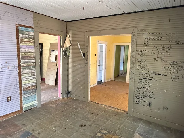 an empty room with closet and wooden floor
