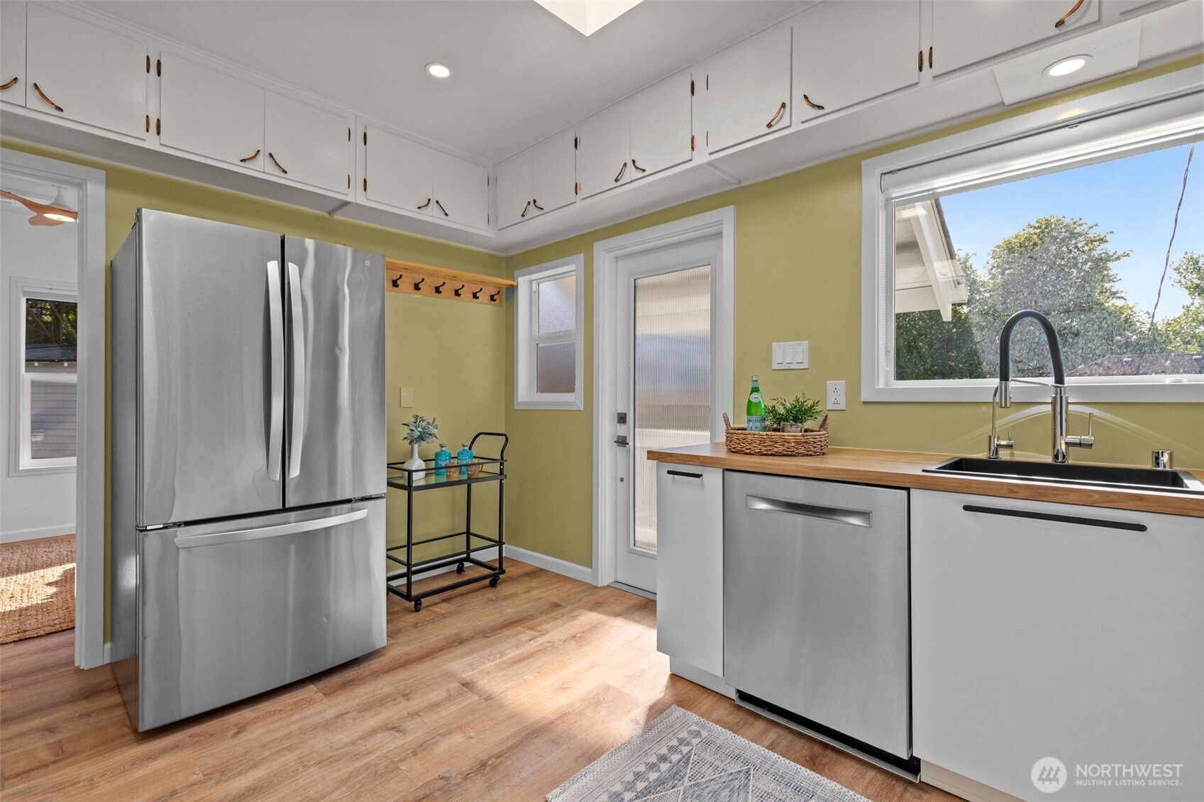 11 West Fulton Street Seattle, WA 98119 - Photo 11 of 40 a kitchen with stainless steel appliances granite countertop a refrigerator a sink and a stove