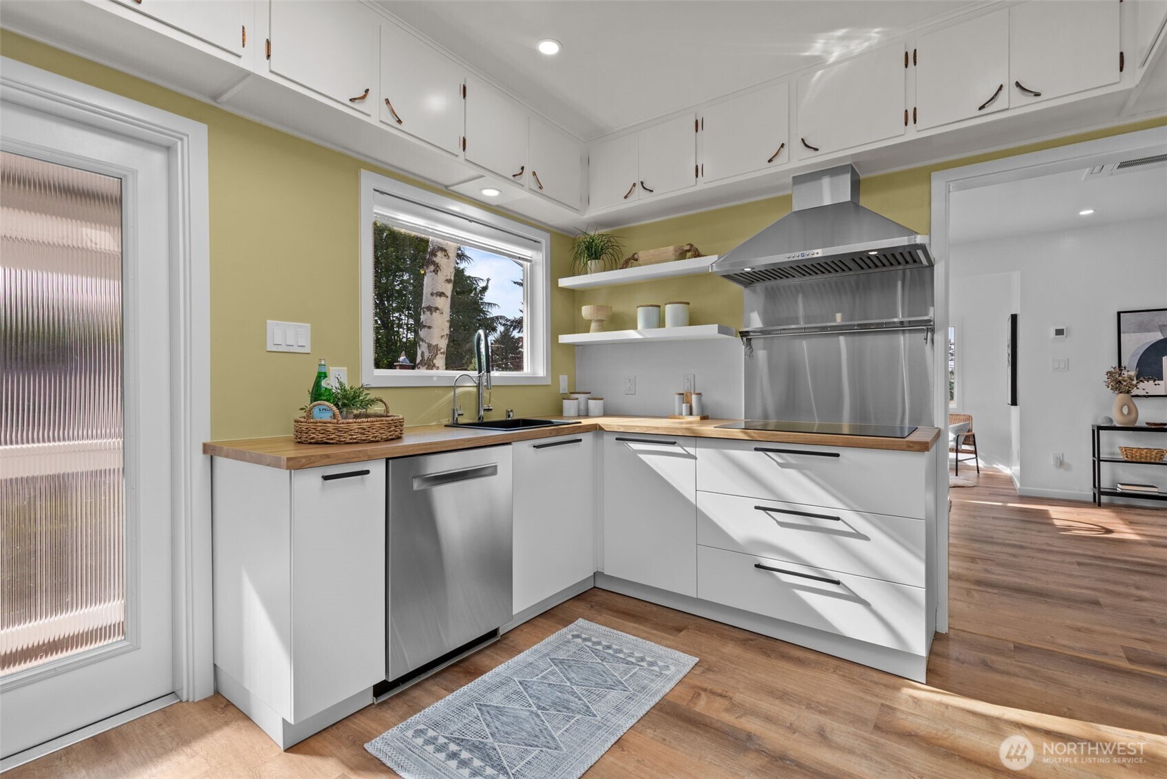 11 West Fulton Street Seattle, WA 98119 - Photo 12 of 40 a large white kitchen with stainless steel appliances granite countertop a refrigerator and a sink