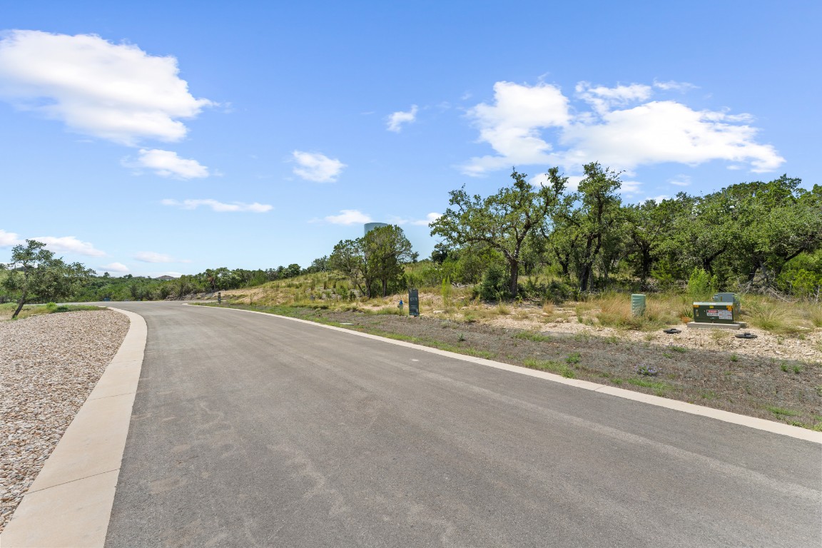 7 B Broadwing Cove Austin, TX 78737 - Photo 8 of 14 a view of a swimming pool with a yard