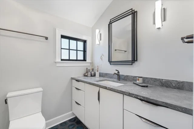 a living room with couches and a dining table with rug