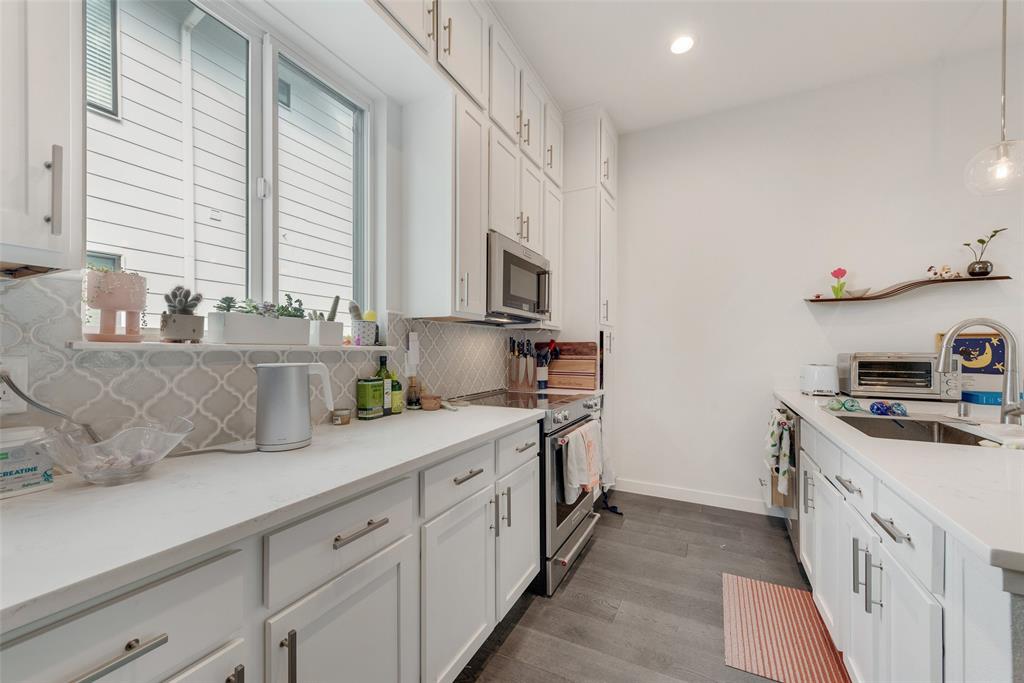 6004 Hudson Street, Unit 102 Dallas, TX 75206 - Photo 11 of 22 a kitchen with a sink stove and cabinets