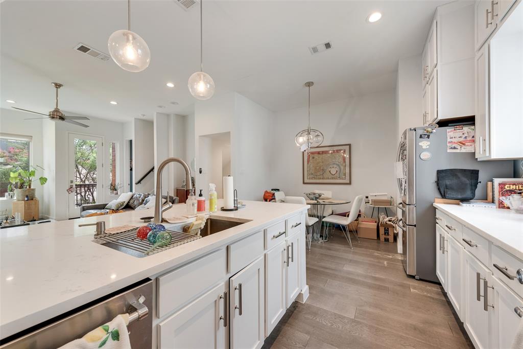 6004 Hudson Street, Unit 102 Dallas, TX 75206 - Photo 22 of 22 a kitchen view with microwave a stove and cabinets