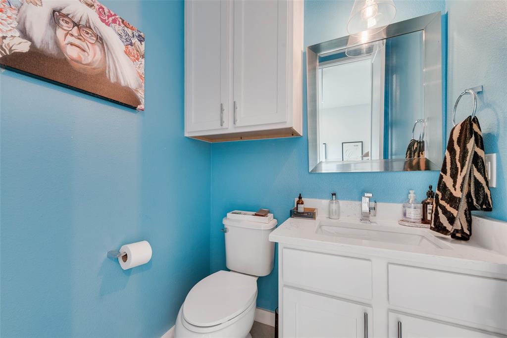 6004 Hudson Street, Unit 102 Dallas, TX 75206 - Photo 12 of 22 a bathroom with a toilet sink and mirror