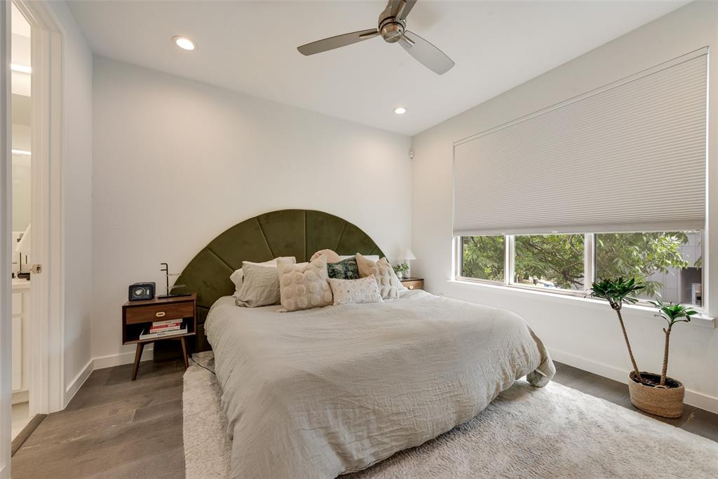 6004 Hudson Street, Unit 102 Dallas, TX 75206 - Photo 13 of 22 a bedroom with a bed and a large window