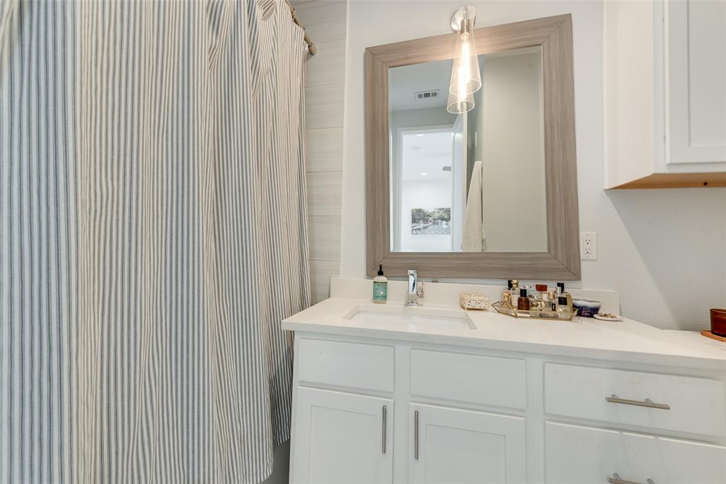 6004 Hudson Street, Unit 102 Dallas, TX 75206 - Photo 17 of 22 a bathroom with a sink and a mirror