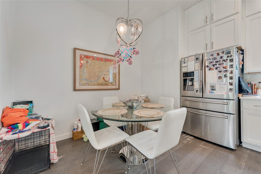 6004 Hudson Street, Unit 102 Dallas, TX 75206 - Photo 9 of 22 a kitchen with stainless steel appliances granite countertop a dining table and chairs