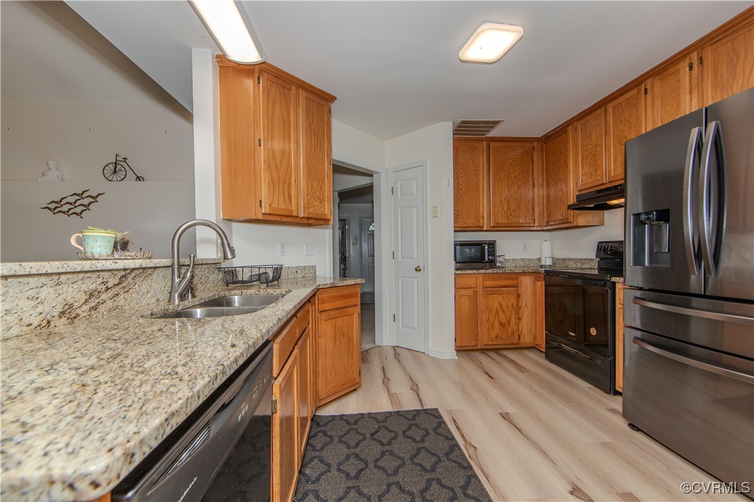 7352 Trailing Rock Road Prince George, VA 23875 - Photo 5 of 18 a kitchen with granite countertop a sink stainless steel appliances and cabinets