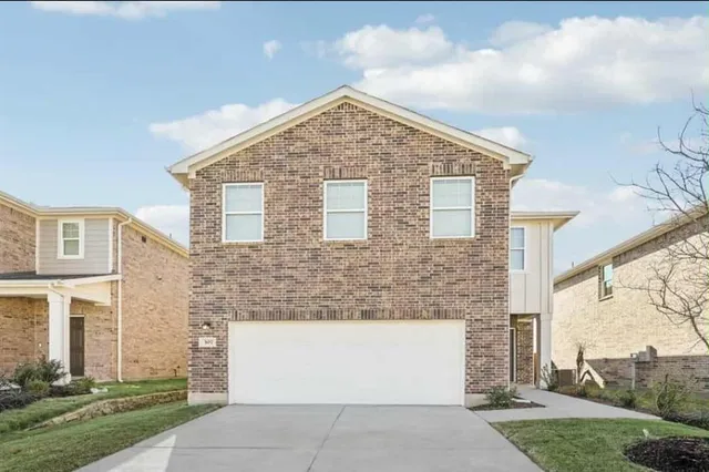 a view of a house with brick walls