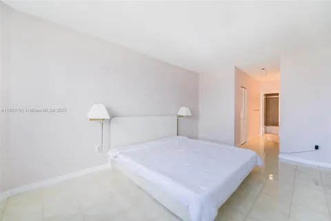 a bedroom with a bed and a night stand