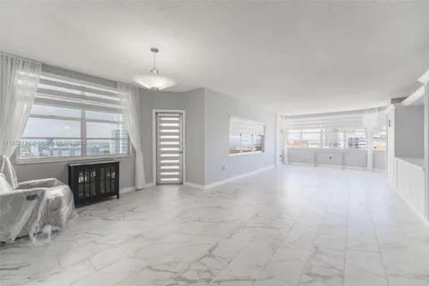 a view of livingroom with furniture fireplace and window