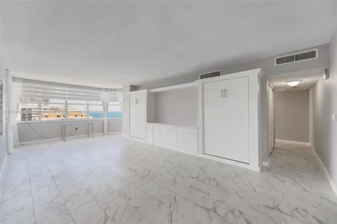 a view of a livingroom with wooden floor and cabinet