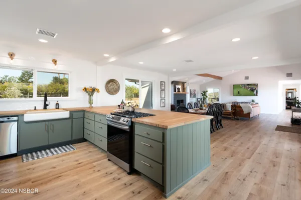 a kitchen with kitchen island granite countertop a sink counter top space and stainless steel appliances
