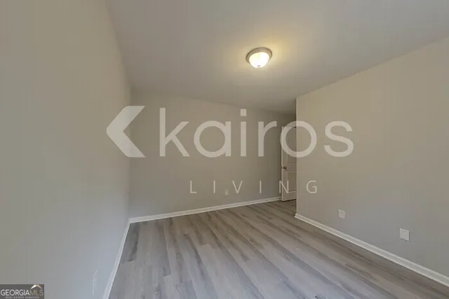 a view of a room with wooden floor