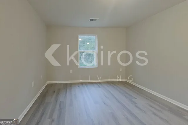 a view of a room with wooden floor