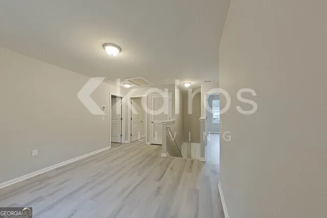 a view of a room with wooden floor