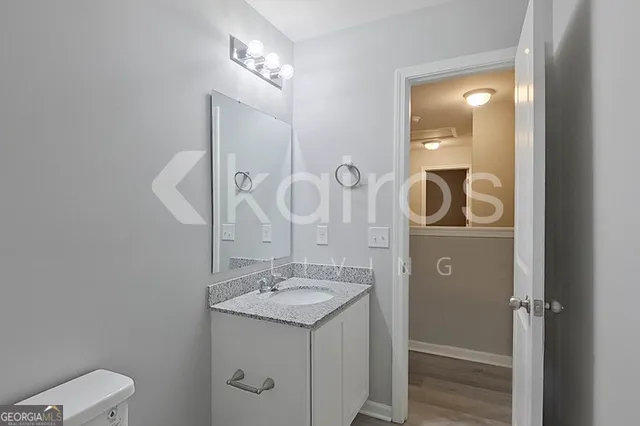 a bathroom with a sink and mirror with toilet