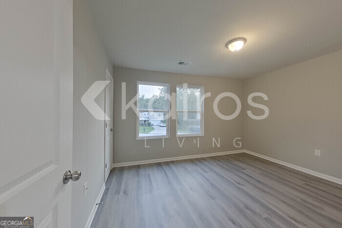 236 Sunrise Circle Midway, GA 31320 - Photo 19 of 31 an empty room with wooden floor and windows