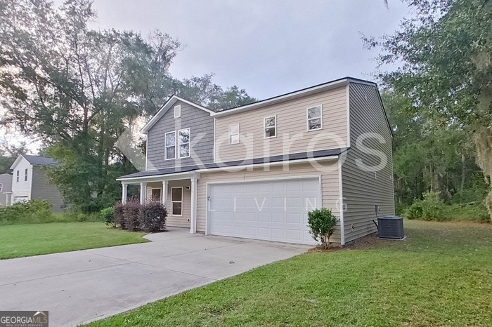236 Sunrise Circle Midway, GA 31320 - Photo 2 of 31 a front view of a house with a garden and plants