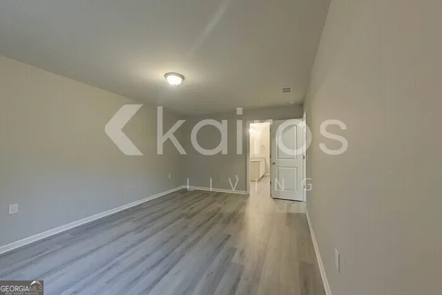 a view of a room with wooden floor