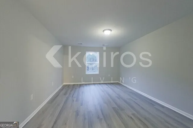 a view of room with window and hardwood floor