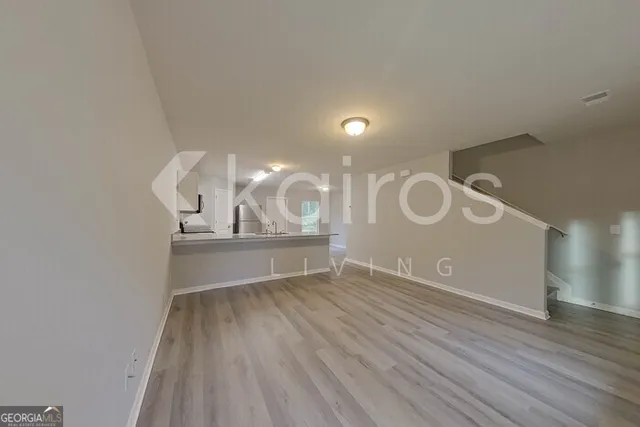 a view of a room with wooden floor