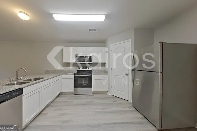 a kitchen with cabinets and stainless steel appliances