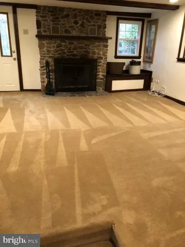 a view of empty room with a fireplace