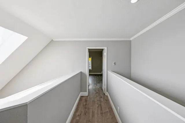 a view of hallway with wooden floor