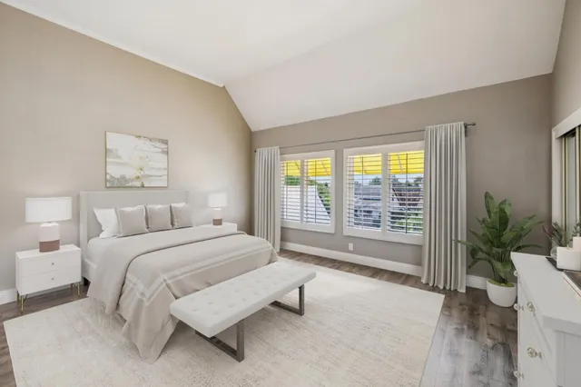 a spacious bedroom with a bed and a large window