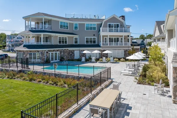 a view of a house with backyard and sitting area