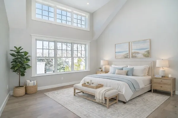 a spacious bedroom with a bed and a window