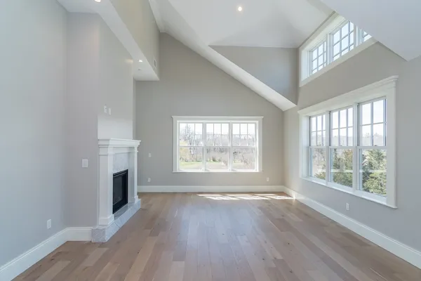 a view of main area with wooden floor and a window