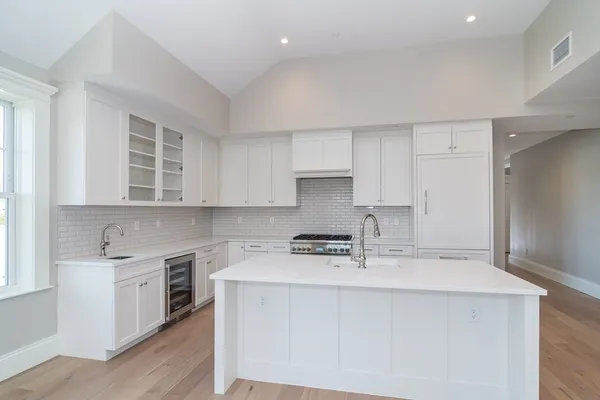 a kitchen with stainless steel appliances a sink stove and cabinets