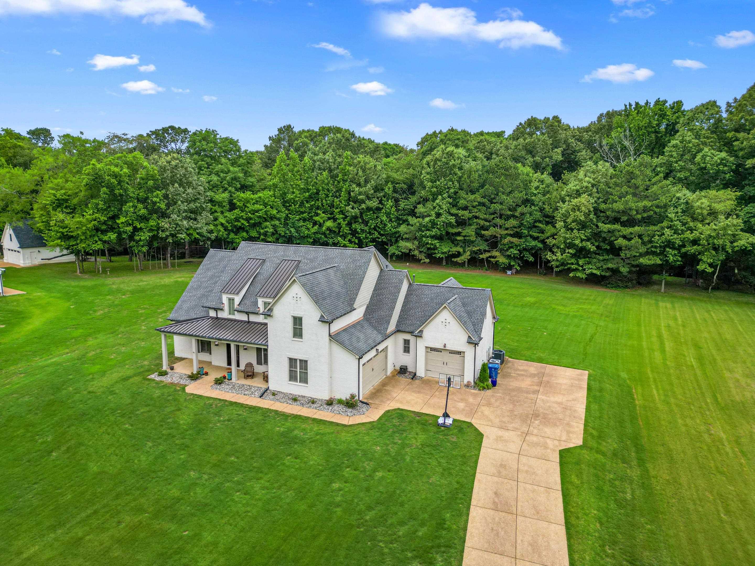 10354 Pleasant Ridge Road Arlington, TN 38002 - Photo 36 of 40 Impressive exterior featuring a charming front porch, long driveway, 3-car garage, and gorgeous curb appeal set on a picturesque oversized lot.