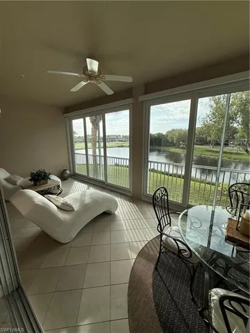 a living room with furniture and a floor to ceiling window