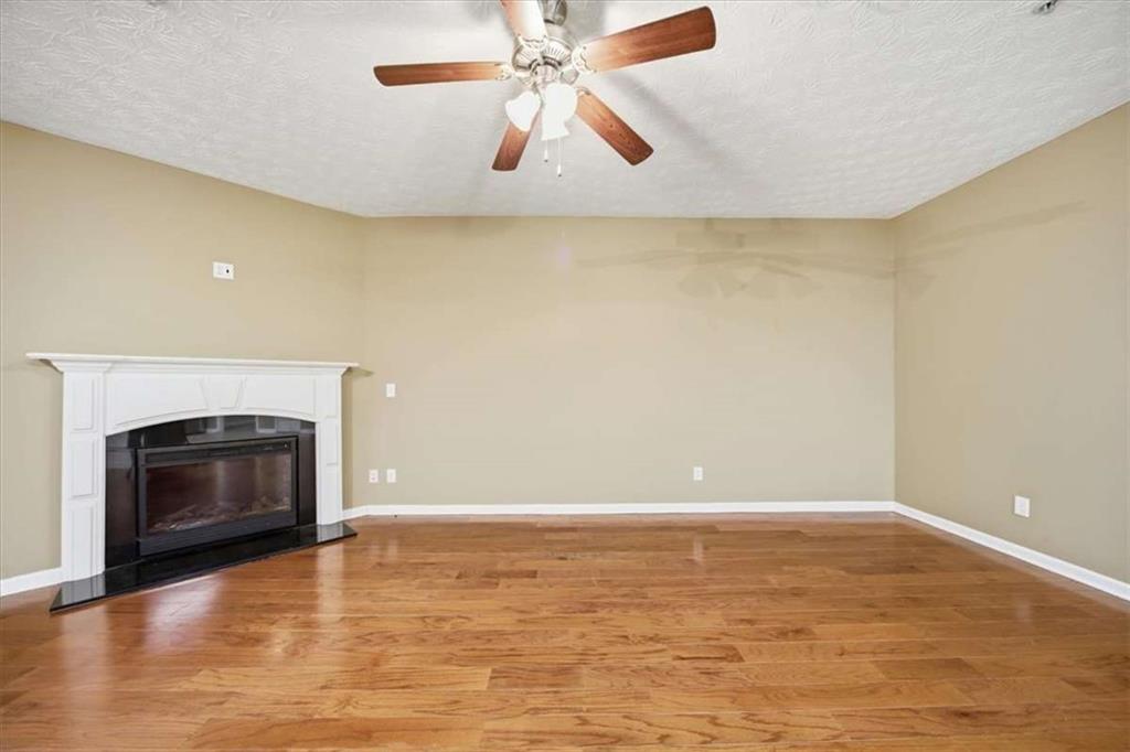 3834 Augustine Place Rex, GA 30273 - Photo 13 of 41 a view of an empty room with wooden floor and a fireplace