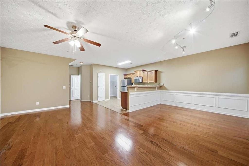 3834 Augustine Place Rex, GA 30273 - Photo 16 of 41 a view of a kitchen with wooden floor and a ceiling fan