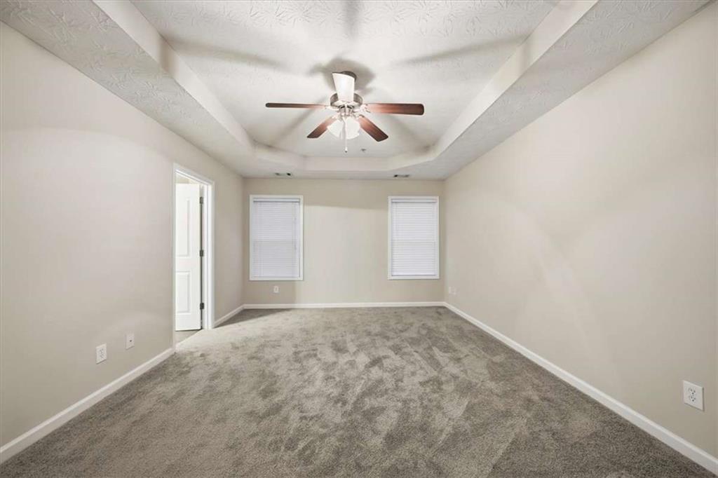 3834 Augustine Place Rex, GA 30273 - Photo 32 of 41 an empty room with chandelier fan and windows