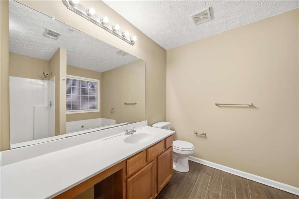3834 Augustine Place Rex, GA 30273 - Photo 35 of 41 a bathroom with a sink a toilet and shower