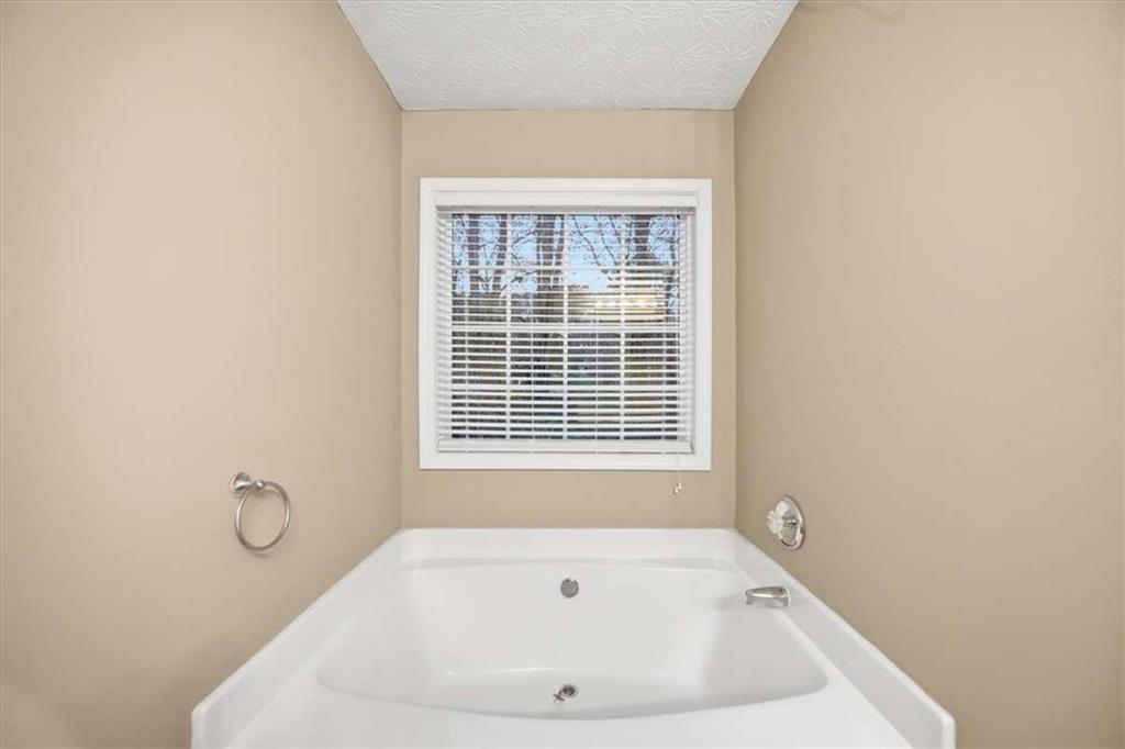 3834 Augustine Place Rex, GA 30273 - Photo 36 of 41 a bath tub sitting in a bathroom next to a window