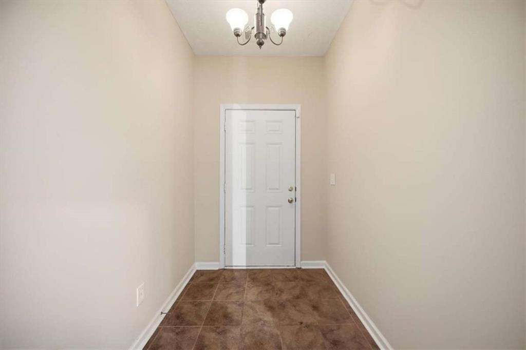 3834 Augustine Place Rex, GA 30273 - Photo 6 of 41 a view of a chandelier fan and hardwood floor