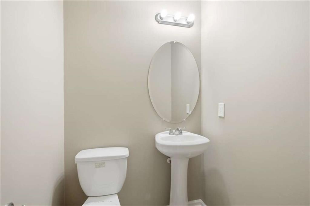 3834 Augustine Place Rex, GA 30273 - Photo 7 of 41 a bathroom with a toilet sink and mirror