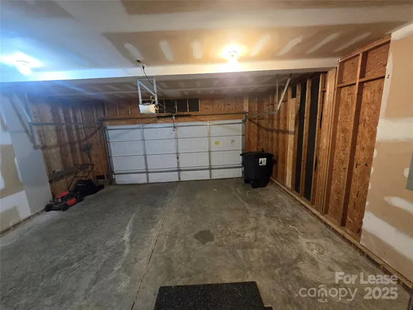 an empty room with windows and cabinet
