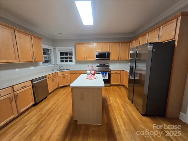 a kitchen with a refrigerator stove and sink