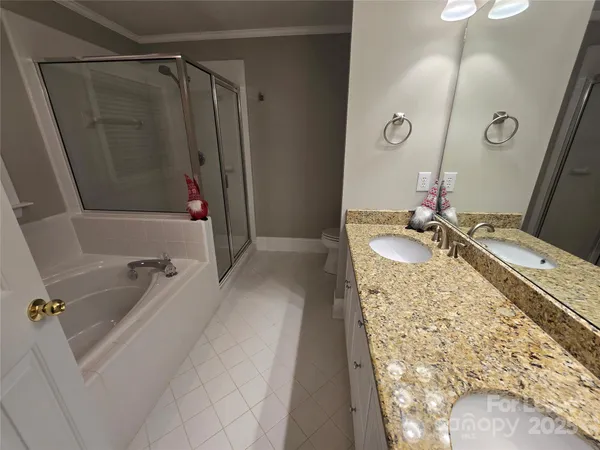 a bathroom with a granite countertop sink a mirror and shower