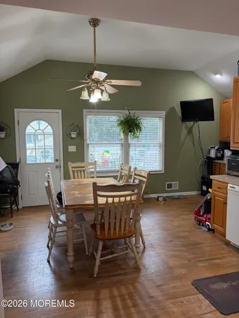 a view of a dining room with furniture window and wooden floor