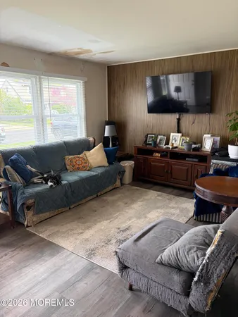 a living room with furniture rug and window